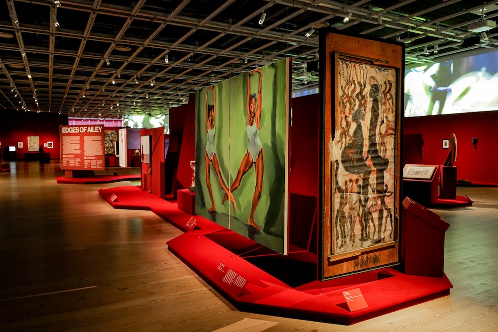 Installation view of Edges of Ailey (Whitney Museum of American Art, New York, September 25, 2024-February 9, 2025). From left to right: Lynette Yiadom-Boakye, Fly Trap, 2024; Purvis Young, Love Dance, 1991. Photograph by Jason Lowrie/BFA.com. © BFA 2024